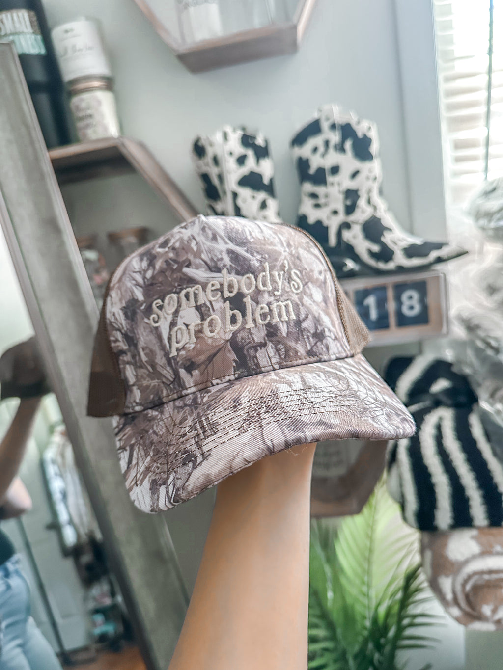 Somebody’s Problem Camo Trucker Hat